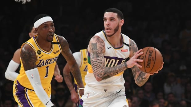 New Orleans Pelicans guard Lonzo Ball looks to pass during a game against Kentavious Caldwell-Pope and the Los Angeles Lakers.